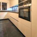 Rénovation d’un appartement à Versailles (78) - grande cuisine blanche et sol gris